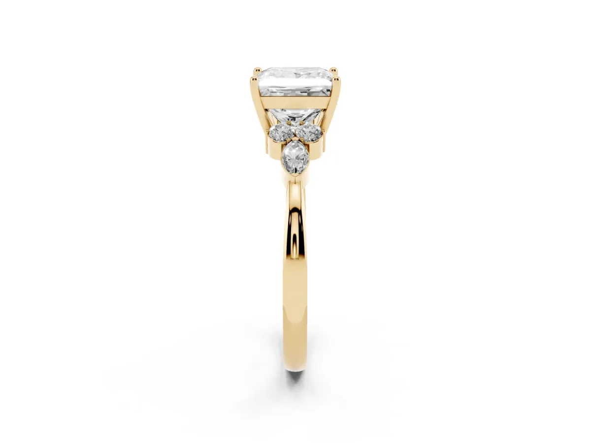 Princess Cut Brilliant Diamond Solitaire Ring with Pear Side Stones and Four-Prong Setting Yellow gold