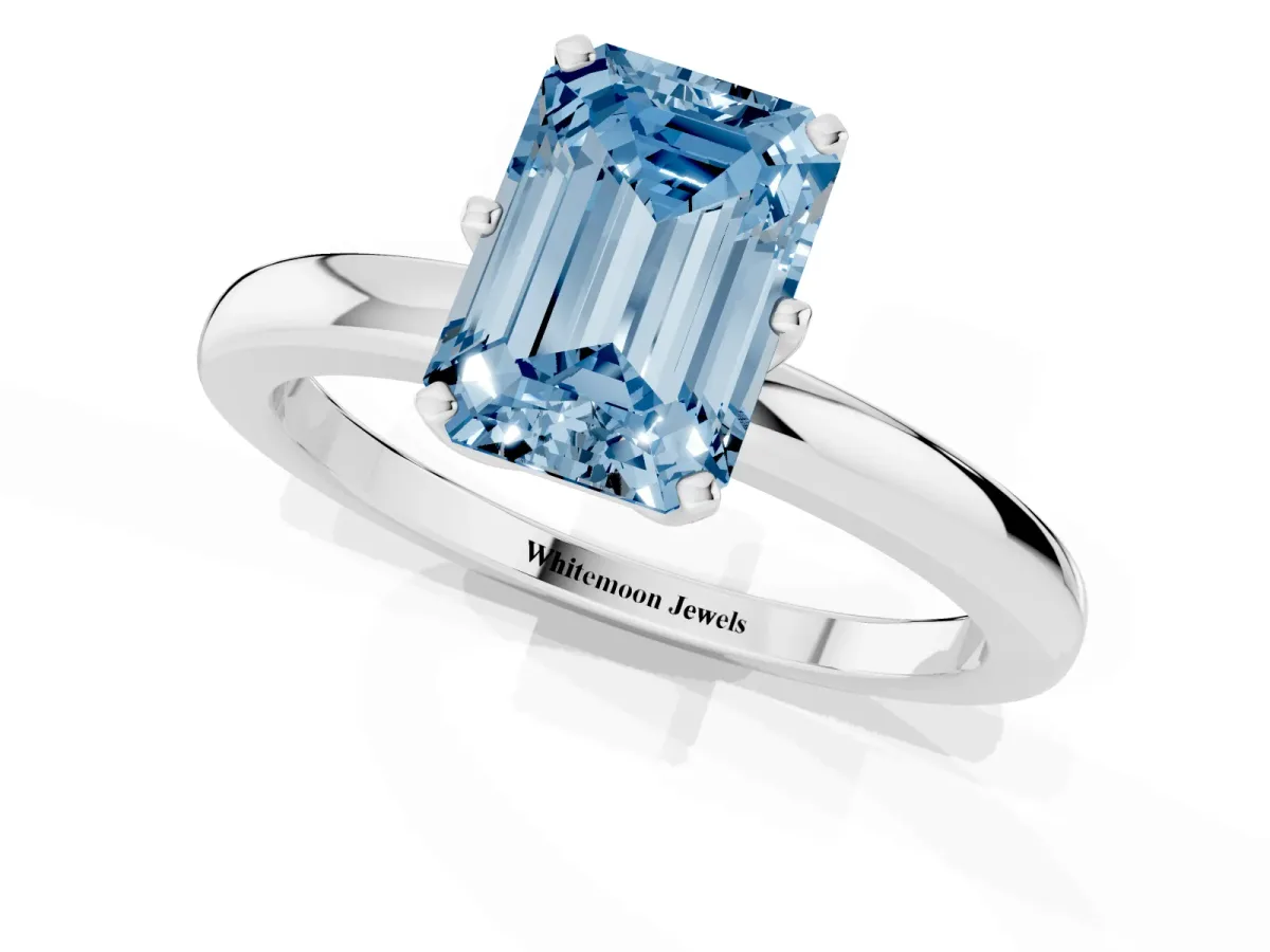Fancy Blue Emerald Cut Solitaire Diamond Ring with Six-Prong Setting on a Classic Band Platinum