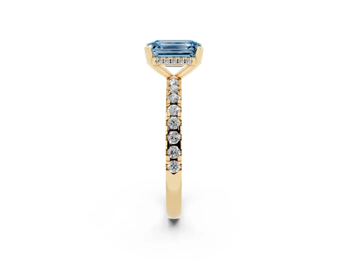 Fancy Blue Emerald Cut Diamond Solitaire Ring with Round Pavé Band and Four-Prong Setting Yellow gold