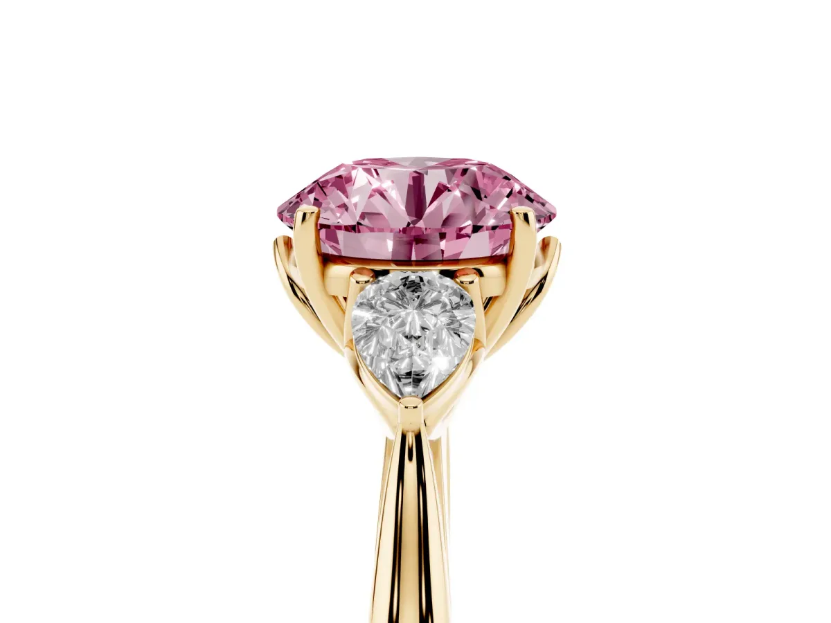 Fancy Pink Round Cut Diamond Three-Stone Ring with Pear Side Stones and Prong Setting Yellow gold