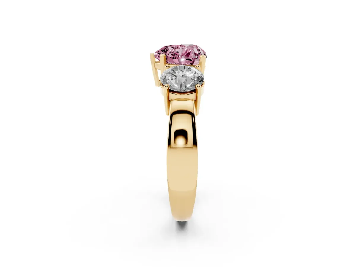 Fancy Pink Three-Stone Heart Cut Diamond Ring with Round Side Stones, Classic Band, and Four-Prong Setting Yellow gold