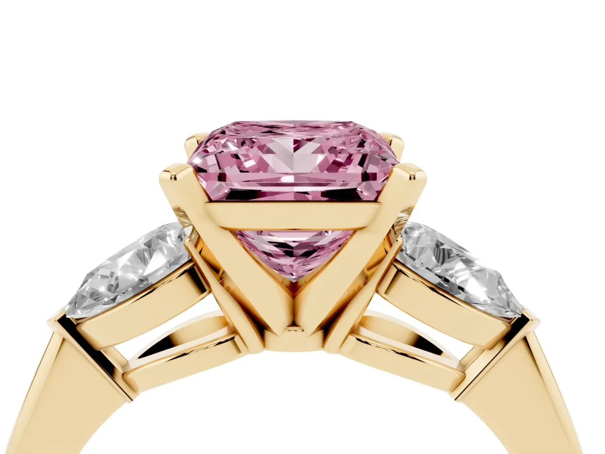 Fancy Pink Three-Stone Princess Cut Diamond Ring with Pear Side Stones and Four-Prong Setting Yellow gold