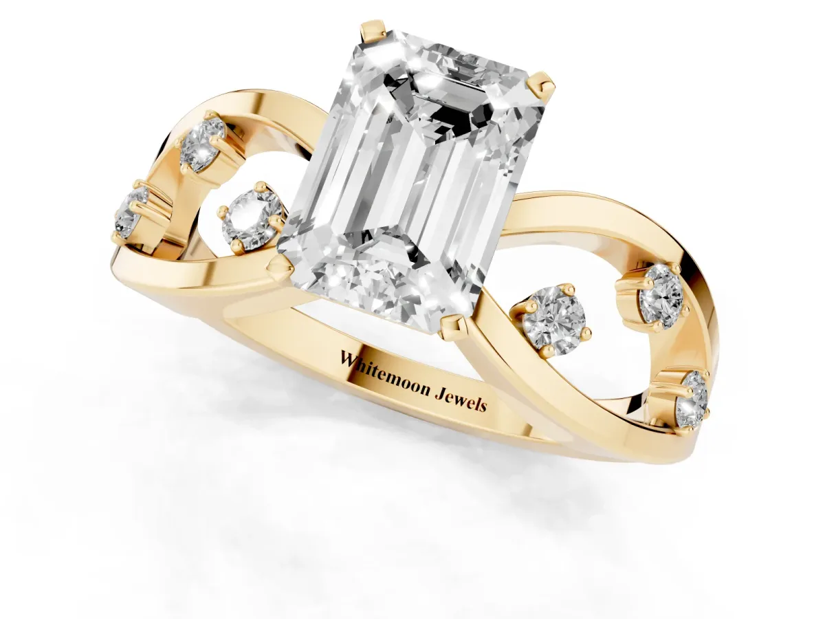 Emerald Cut Cut Solitaire Diamond with Side Stones on Criss-Cross Band and Four-Prong Setting Yellow gold