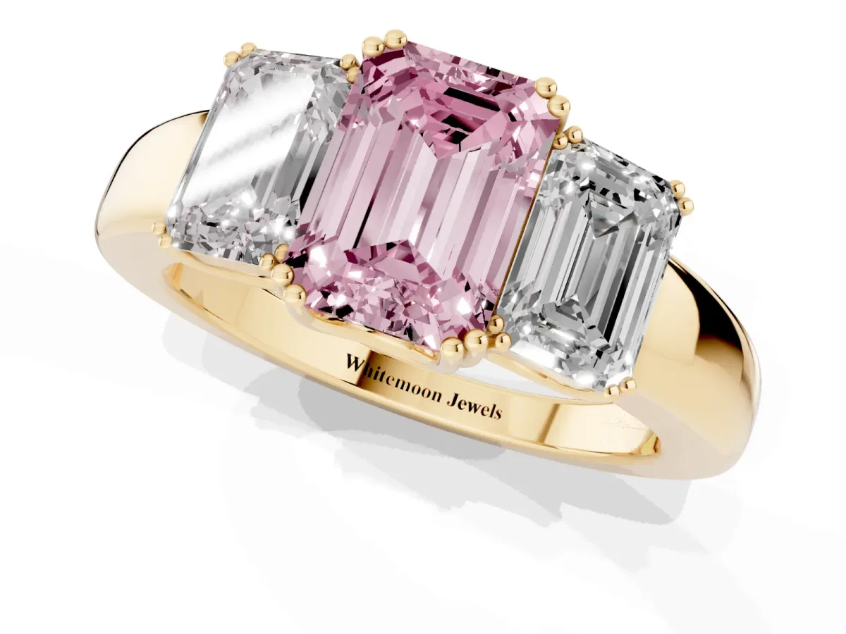 Fancy Pink Three-Stone Emerald Cut Cut Diamond Ring with Channel Set Band and Four-Prong Setting Yellow gold