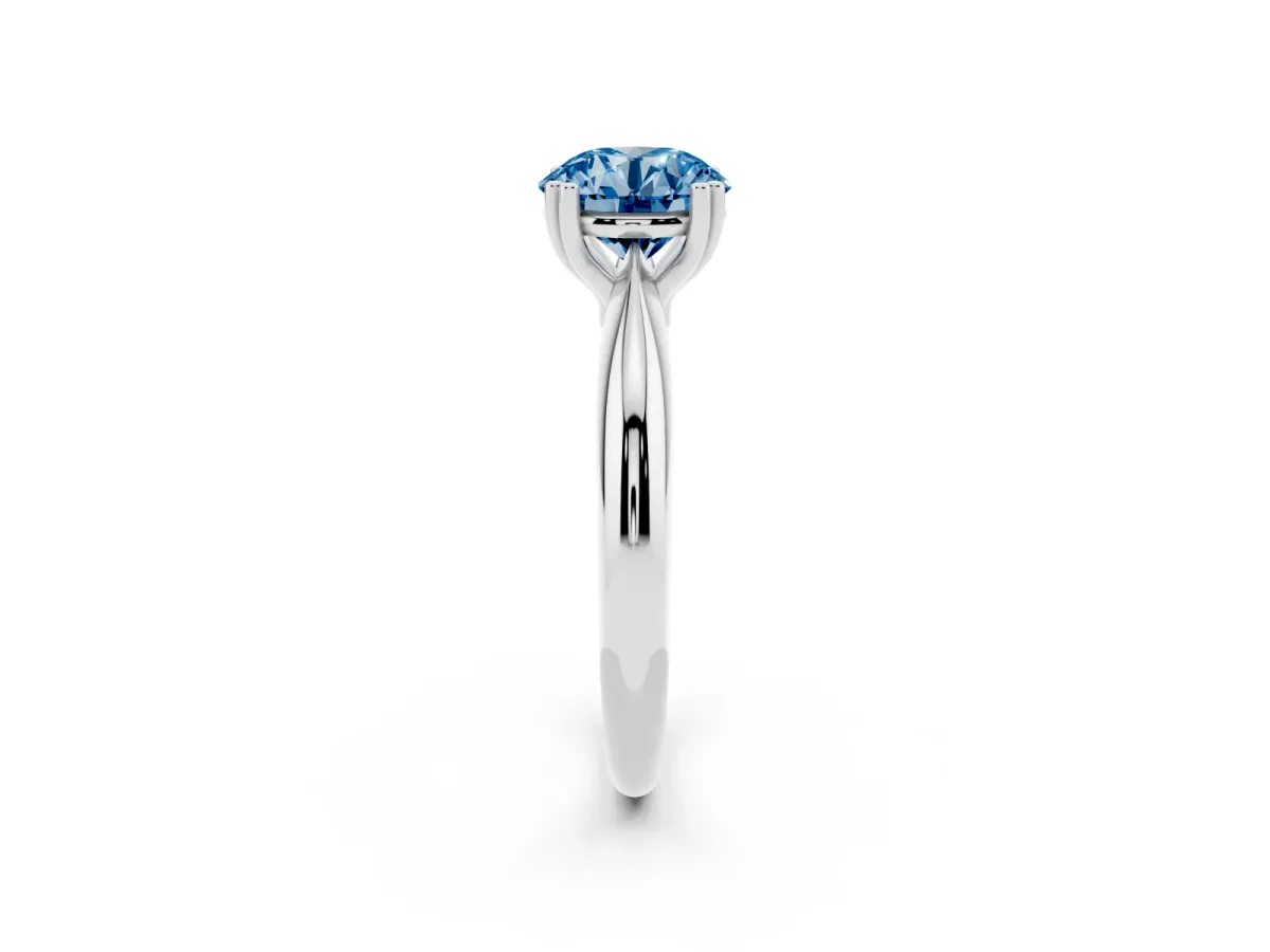 Fancy Blue Round Cut Cut Solitaire Engagement Ring with Tapered Band and Four-Prong Setting Silver