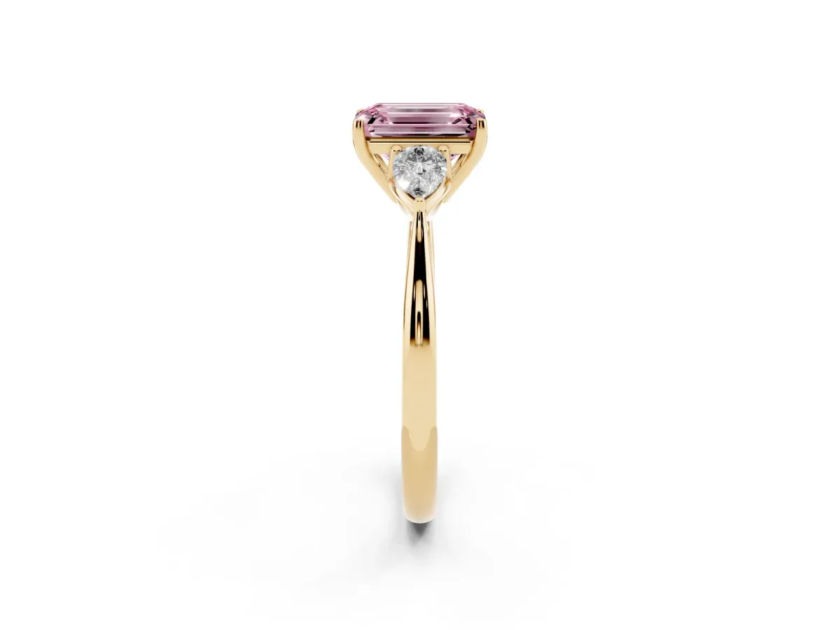 Fancy Pink Three-Stone Emerald Cut Diamond Ring with Pear Side Stones in Four-Prong Setting Yellow gold