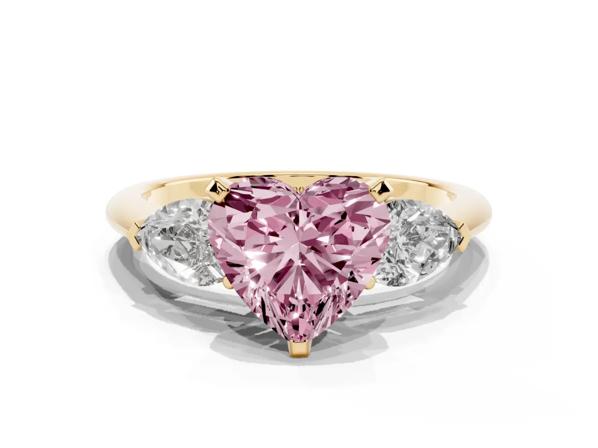 Fancy Pink Three-Stone Heart Cut Diamond Ring with Pear Side Stones and Four-Prong Setting Yellow gold