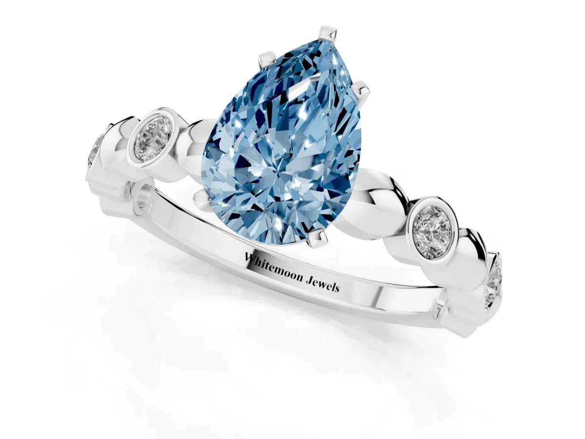 Fancy Blue Pear Cut Solitaire Bezel-Set Diamond Ring with Beaded Band and Four-Prong Setting Silver