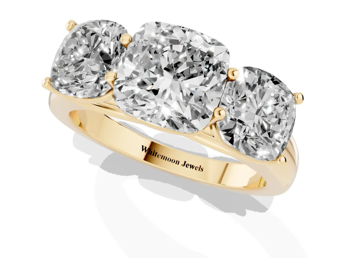 Cushion Cut Three-Stone Diamond Ring with Prong Setting on a Classic Band Yellow gold