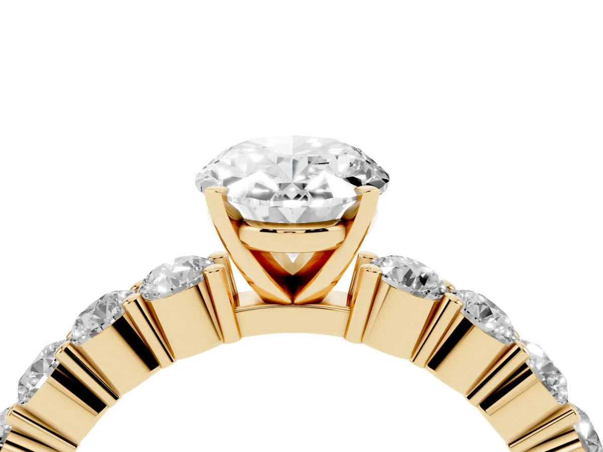Oval Cut Diamond Solitaire Ring with Shared Prong Round Side Stones Yellow gold