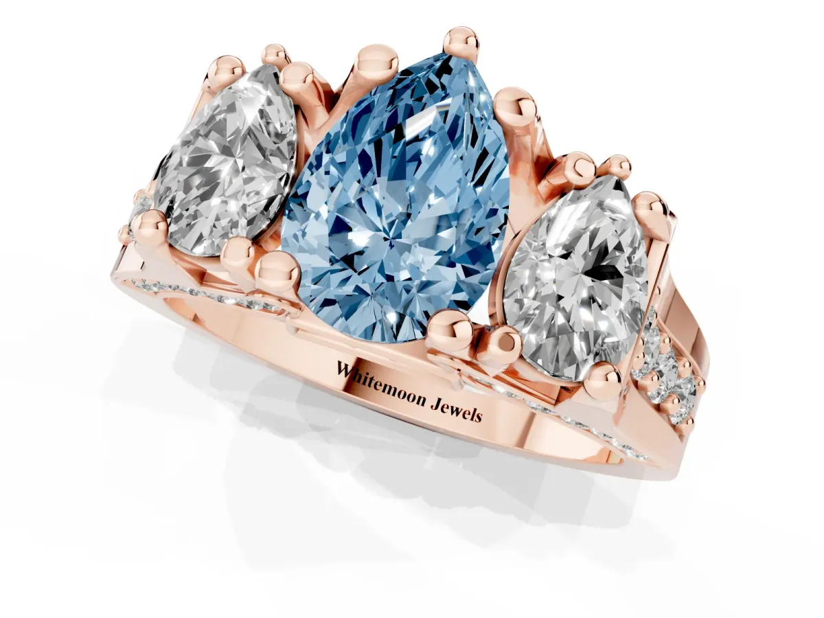 Fancy Blue Pear Cut Diamond Three-Stone Ring with Channel Set Band and Four-Prong Setting Rose gold