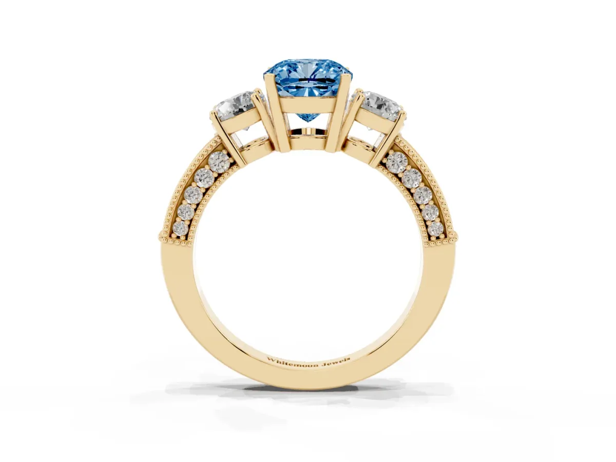 Fancy Blue Cushion Cut Three-Stone Diamond Ring with Pavé Band and Four-Prong Setting Yellow gold