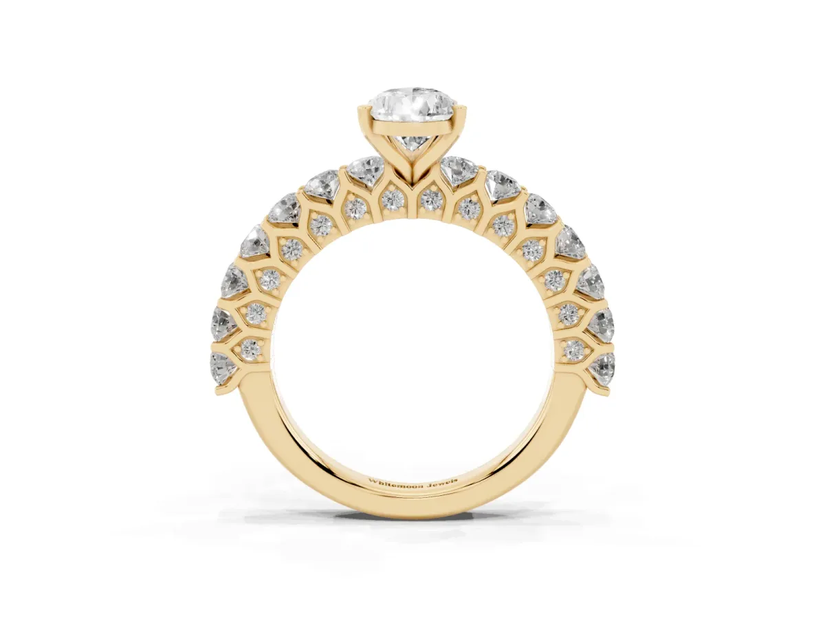 Pear Cut Diamond Solitaire Ring with Shared Prong Pavé Band and Four-Prong Setting Yellow gold