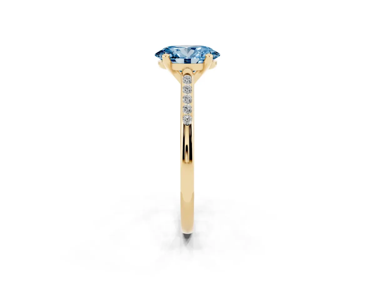 Fancy Blue Oval Cut Diamond Solitaire Ring with Channel Set Round Band and Prong Setting Yellow gold