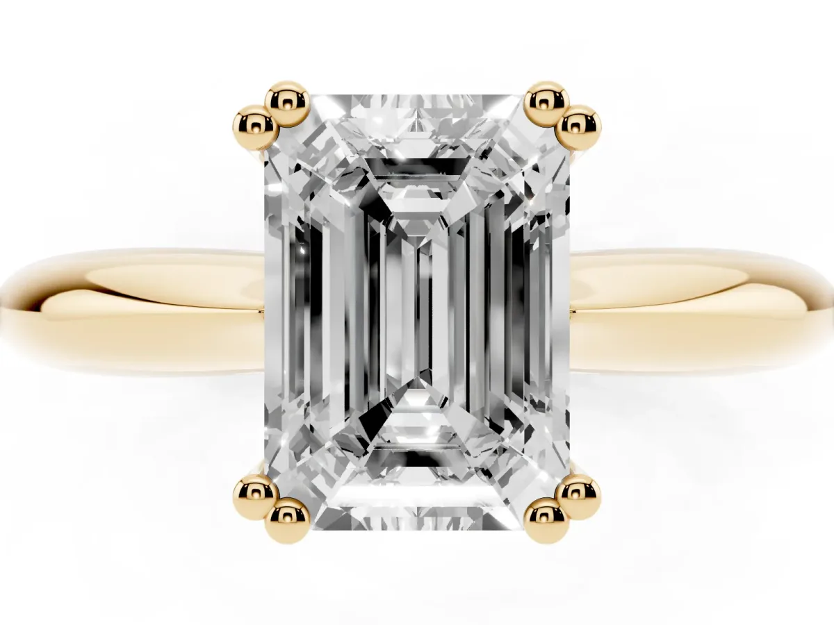 Emerald Cut Cut Solitaire Engagement Ring with Tapered Band and Four-Prong Setting Yellow gold