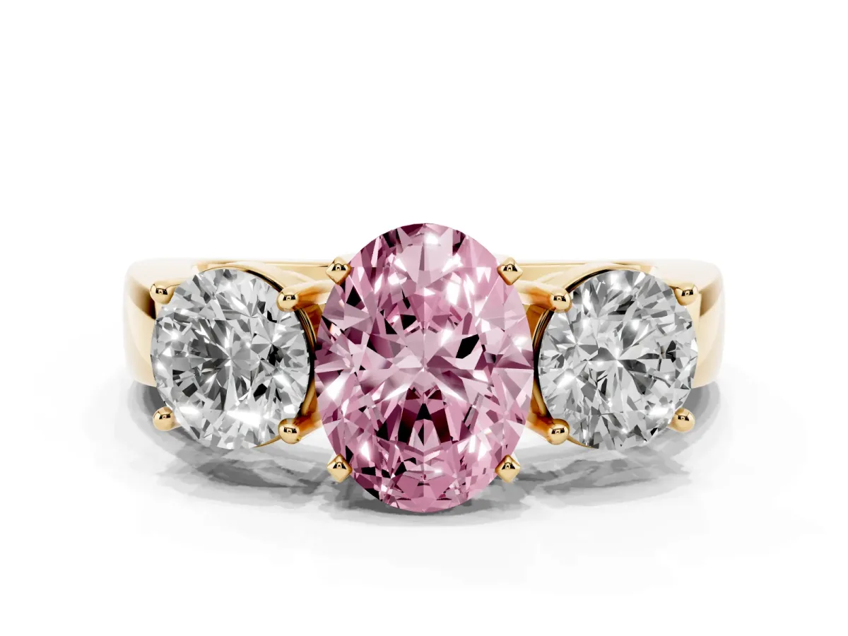 Fancy Pink Three-Stone Oval Cut Diamond Ring with Round Side Stones, Classic Band, and Four-Prong Setting Yellow gold