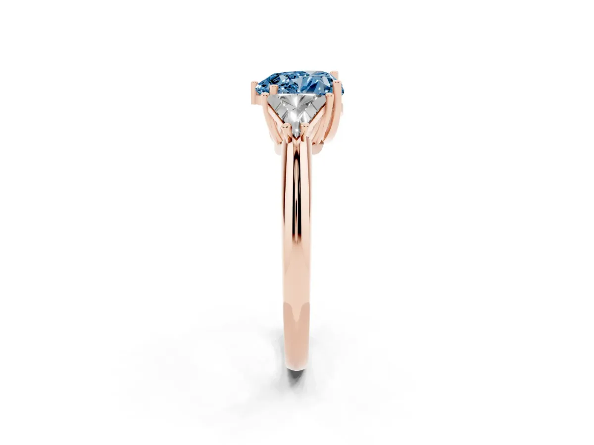 Fancy Blue Three-Stone Heart Cut Diamond Engagement Ring with Trillion Side Stones and Prong Setting Rose gold