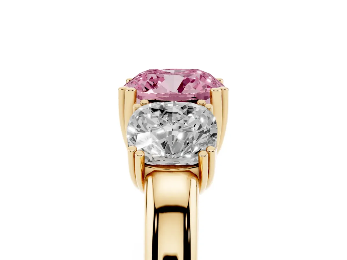 Fancy Pink Three-Stone Cushion Cut Cut Diamond Ring with Channel Set Band and Four-Prong Setting Yellow gold