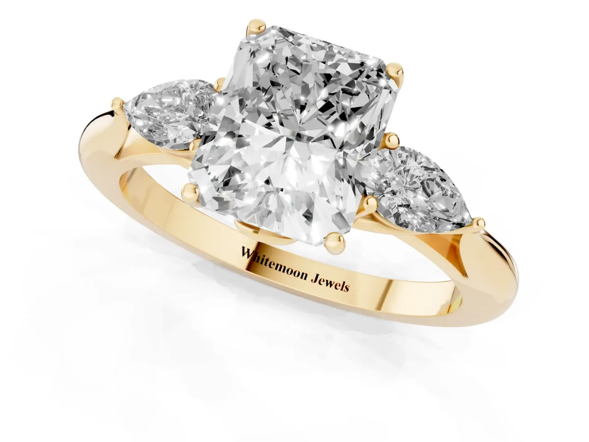 Radiant Cut Diamond Three-Stone Ring with Pear Side Stones and Prong Setting Yellow gold