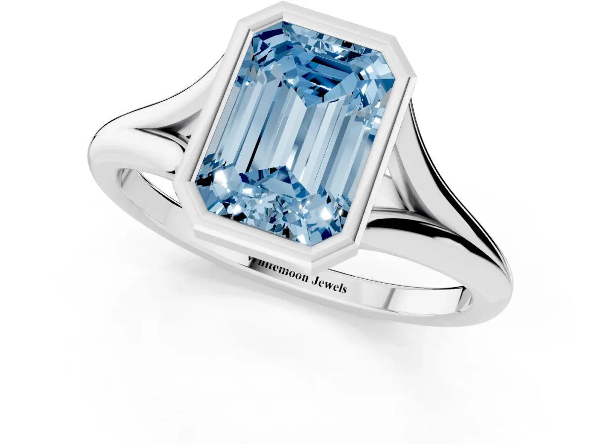 Fancy Blue Bezel Set Emerald Cut Cut Solitaire Ring with Tapered Band Silver
