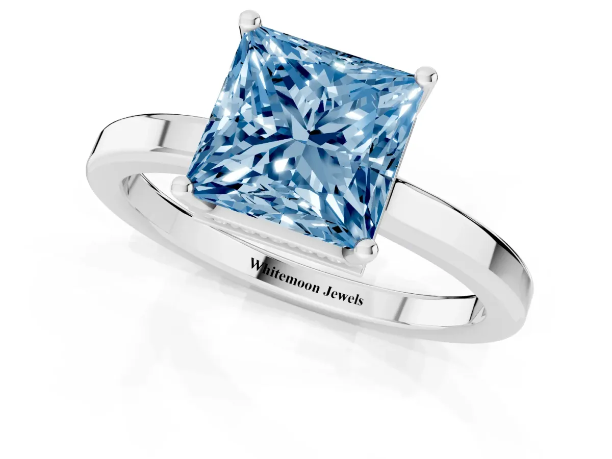 Fancy Blue Princess Cut Cut Solitaire Engagement Ring with Four-Prong Setting on a Classic Band Silver