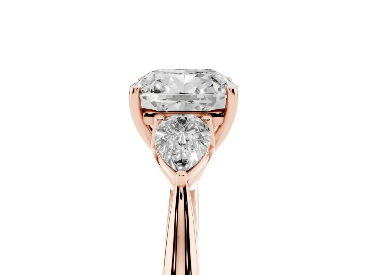 Three-Stone Cushion Cut Diamond Ring with Pear Side Stones in Four-Prong Setting Rose gold