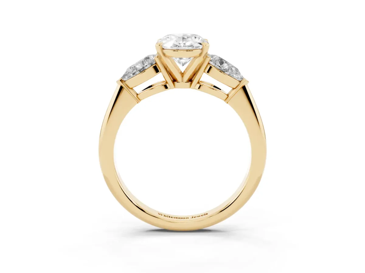 Three-Stone Oval Cut Diamond Ring with Pear Side Stones and Four-Prong Setting Yellow gold