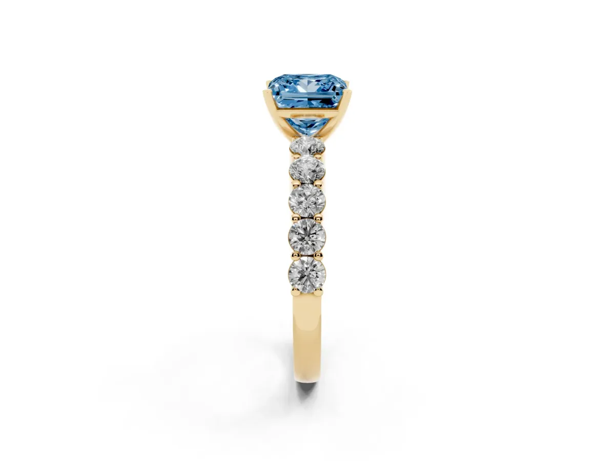 Fancy Blue Princess Cut Diamond Solitaire Ring with Shared Prong Round Side Stones Yellow gold