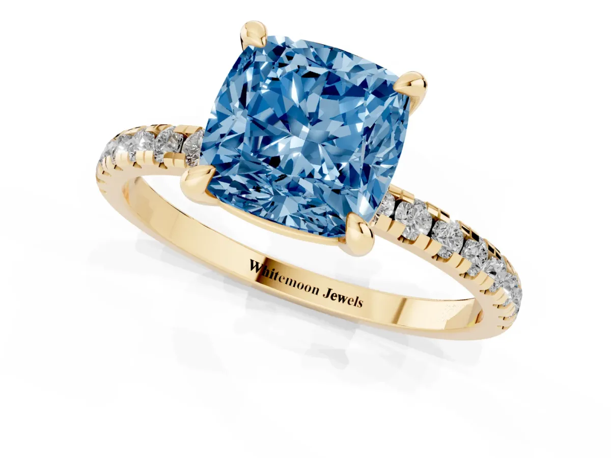 Fancy Blue Cushion Cut Diamond Brilliant Solitaire Ring with Pavé Band and Four-Prong Setting Yellow gold
