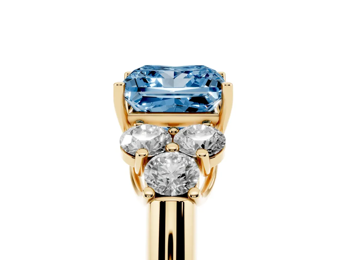 Fancy Blue Princess Cut Cut Diamond Cluster Ring with Round Accent Stones and Prong Setting on a Classic Band Yellow gold