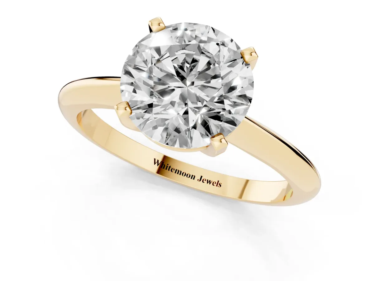 Round Cut Cut Solitaire Ring with Four-Prong Setting on a Classic Band Yellow gold