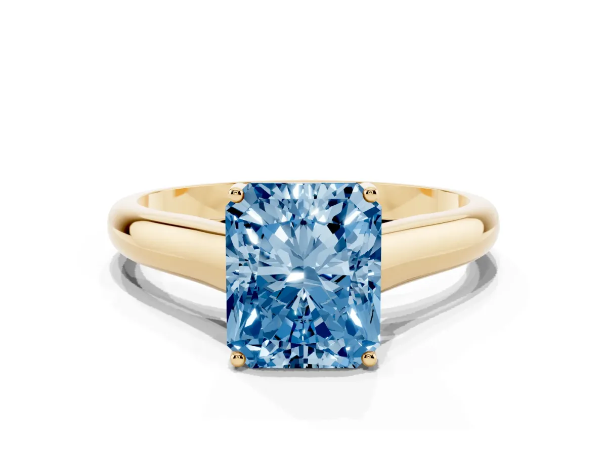 Fancy Blue Radiant Cut Solitaire Engagement Ring with Tapered Band and Four-Prong Setting Yellow gold