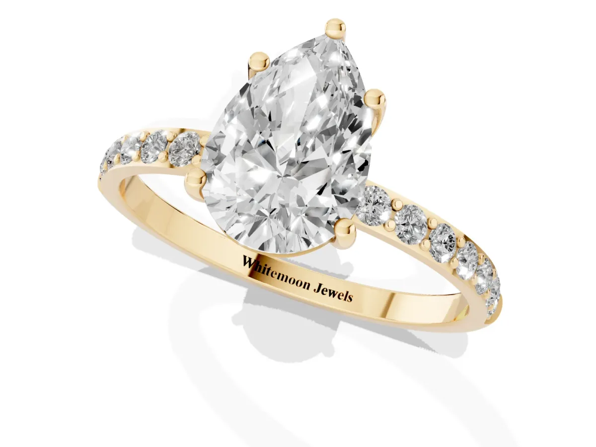 Pear Cut Diamond Solitaire Ring with Round Pavé Shoulders and Prong Setting Yellow gold