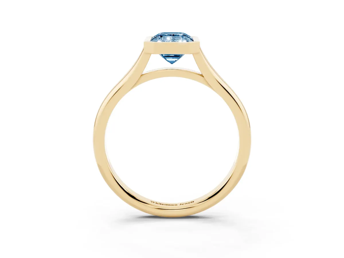 Fancy Blue Bezel Set Emerald Cut Cut Solitaire Ring with Tapered Band Yellow gold