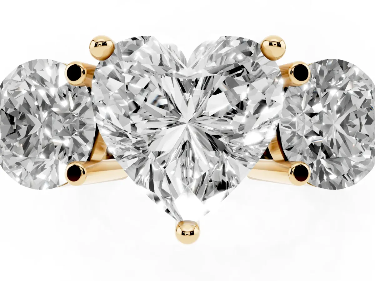 Three-Stone Heart Cut Brilliant Cut Solitaire Ring with Prong Setting on a Classic Band Yellow gold