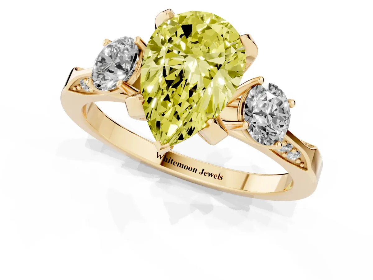 Fancy Yellow Pear Cut Brilliant Three-Stone Diamond Ring with Pavé Band and Four-Prong Setting Yellow gold
