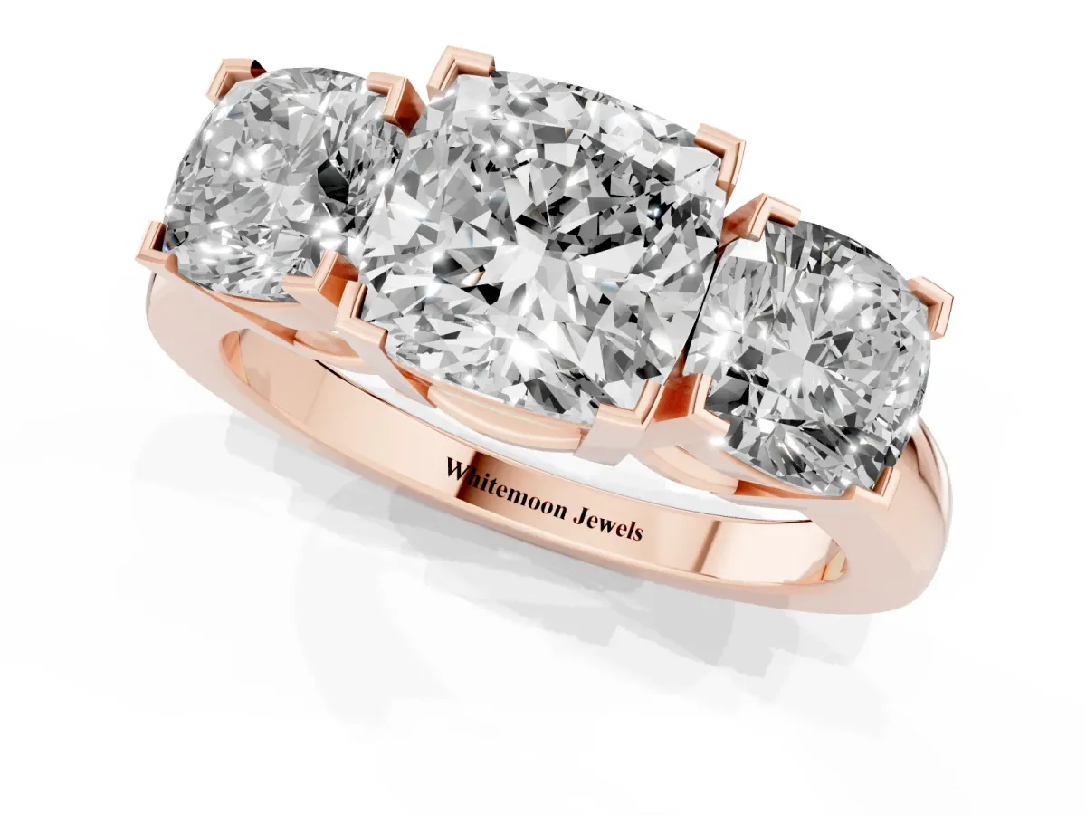 Three-Stone Cushion Cut Cut Diamond Ring with Channel Set Band and Four-Prong Setting Rose gold