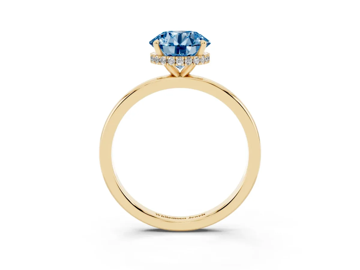 Fancy Blue Round Cut Solitaire Engagement Ring with Cathedral Band and Four-Prong Setting Yellow gold