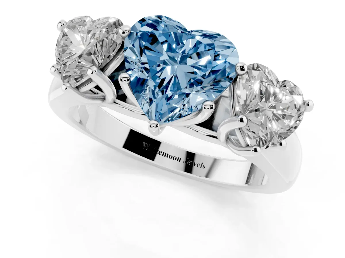 Fancy Blue Heart Cut Three-Stone Diamond Ring with Prong Setting on a Classic Band Platinum