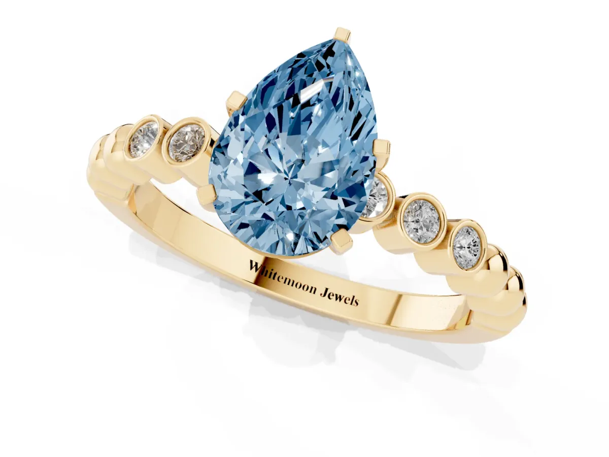 Fancy Blue Pear Cut Solitaire Bezel Accent Diamond Engagement Ring with Beaded Band and Four-Prong Setting Yellow gold