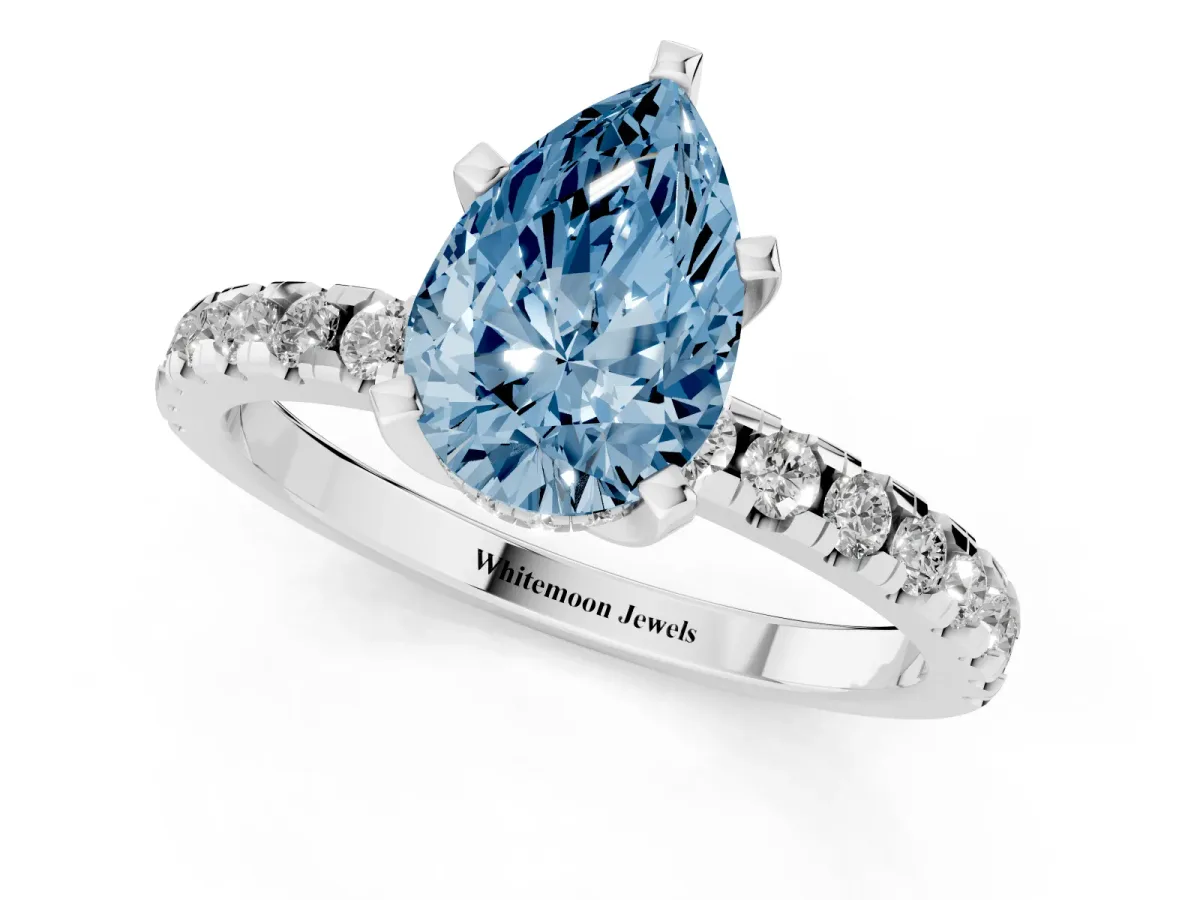 Fancy Blue Pear Cut Diamond Solitaire Ring with Round Pavé Band and Four-Prong Setting Silver