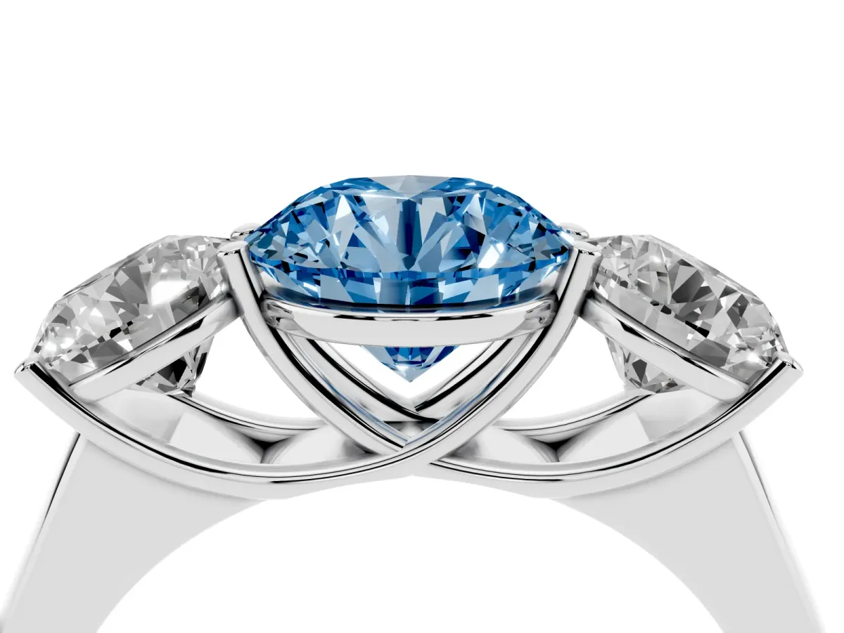 Fancy Blue Round Cut Three-Stone Diamond Ring with Prong Setting on a Classic Band Silver