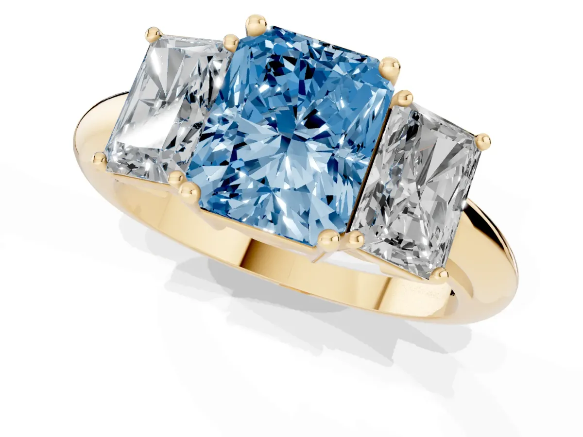 Fancy Blue Three-Stone Radiant Cut Cut Diamond Engagement Ring with Prong Setting on a White Gold Band Yellow gold