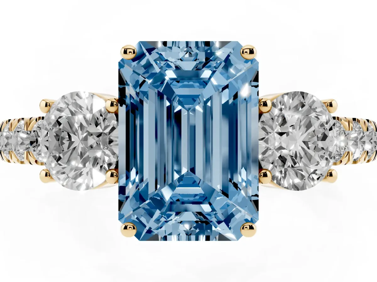 Fancy Blue Emerald Cut Cut Diamond Three-Stone Ring with Round Side Stones and Pavé Band Yellow gold