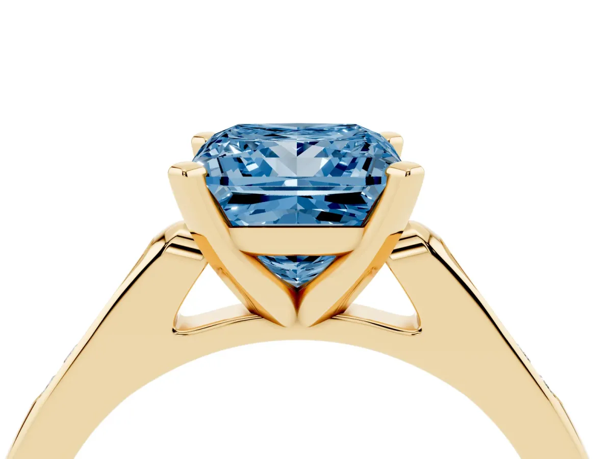 Fancy Blue Princess Cut Diamond Solitaire Ring with Channel Set Round Band and Prong Setting Yellow gold