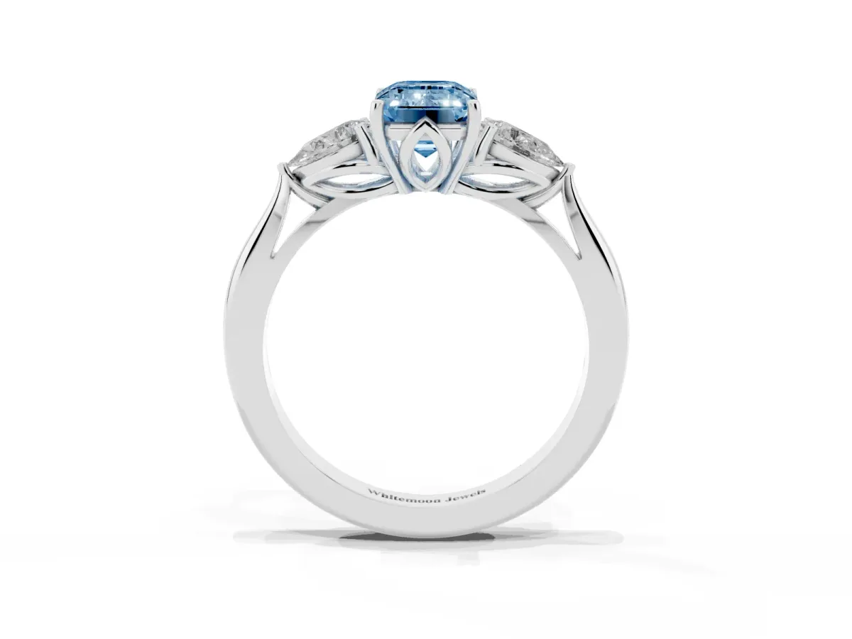 Fancy Blue Three-Stone Emerald Cut Brilliant Diamond Solitaire Ring with Tapered Band and Four-Prong Setting White gold