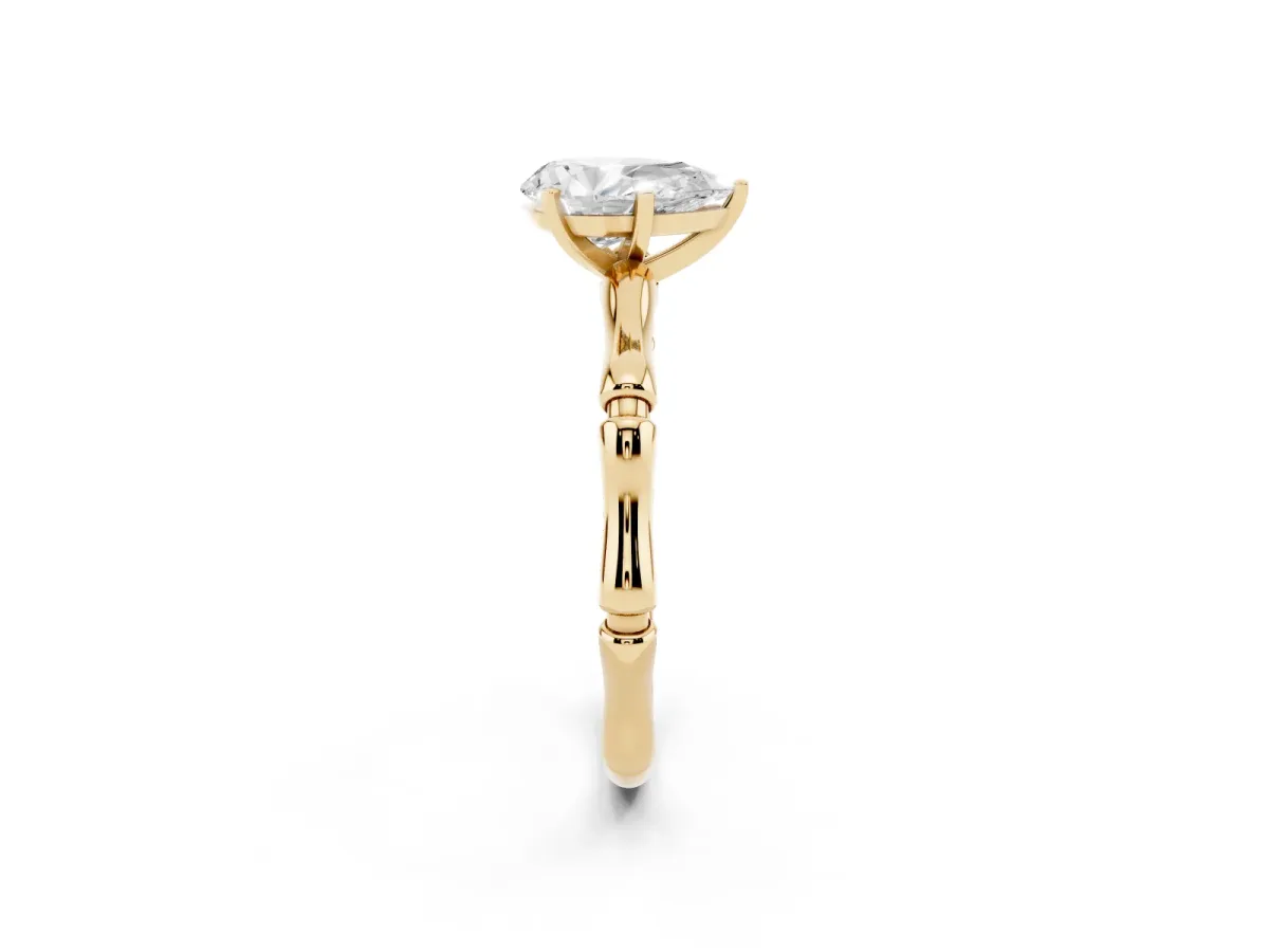 Pear Cut Solitaire Diamond Ring with Bamboo Band and Four-Prong Setting Yellow gold