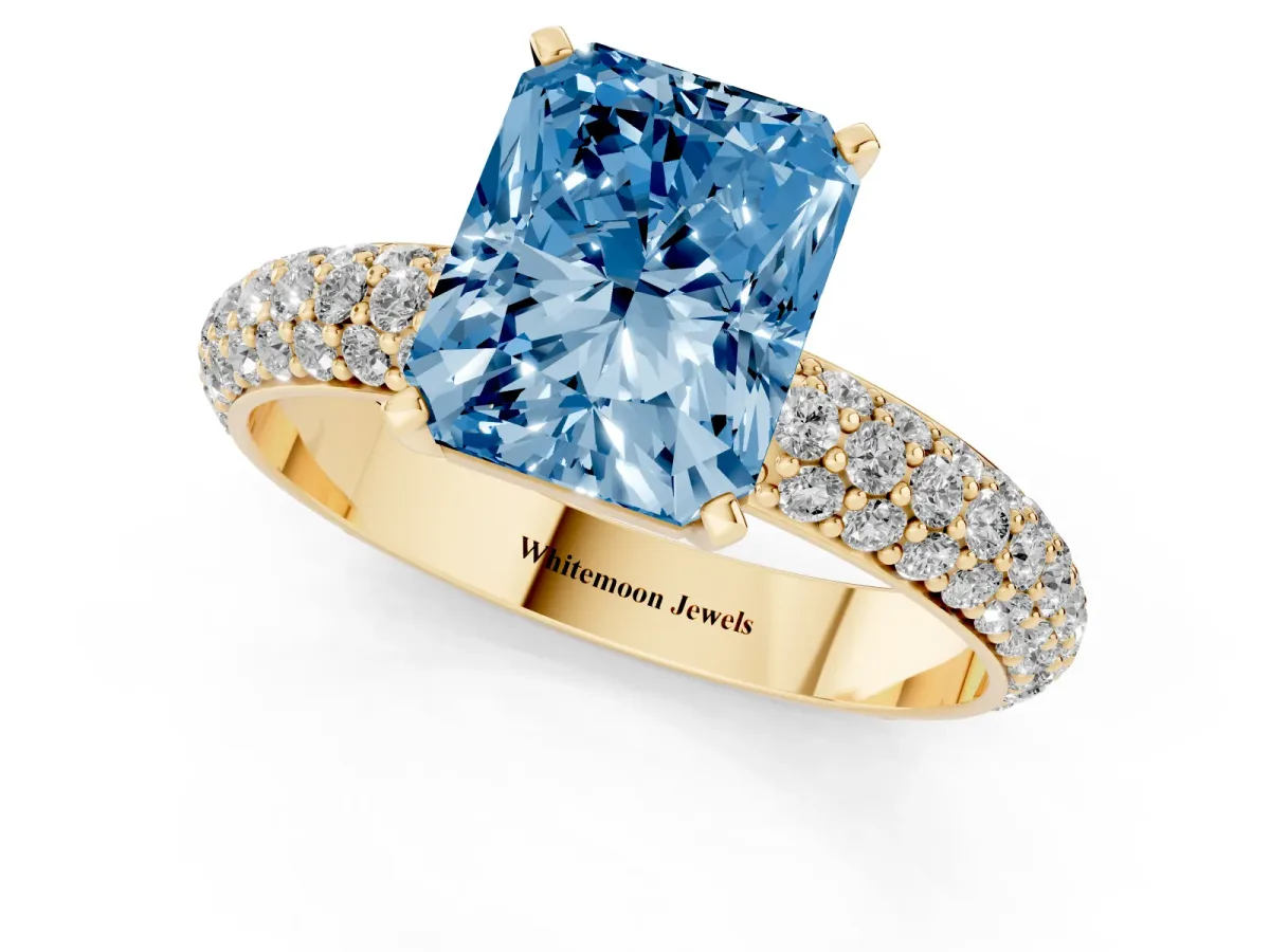 Fancy Blue Radiant Cut Diamond Solitaire Ring with Prong Setting and Pavé Band Yellow gold