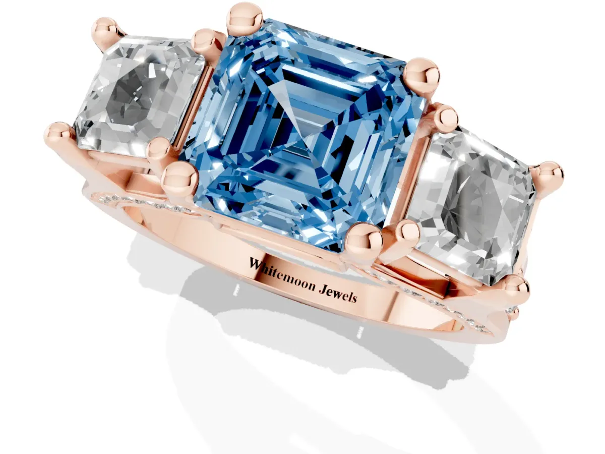 Fancy Blue Asscher Cut Diamond Three-Stone Ring with Channel Set Band and Four-Prong Setting Rose gold