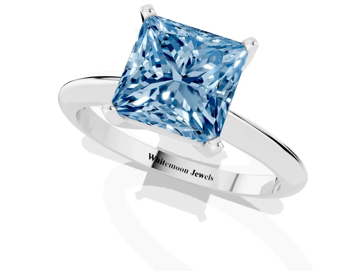 Fancy Blue Princess Cut Cut Solitaire Ring with Four-Prong Setting on a Classic Band Silver